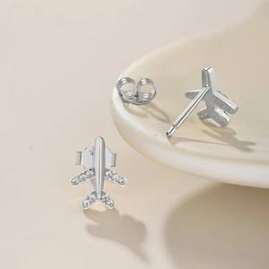 Macro view of airplane stud earrings in S925 silver with sparkling zircon details
