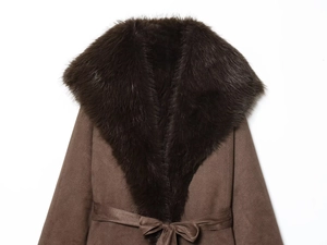 Detail of plush faux fur collar and waist tie on a slim-fit dark brown winter coat