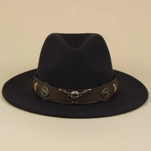 Detail of western fedora hat featuring brown leather band and silver bull head ornament