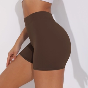 Detail of high-waist yoga shorts showing seamless compression and scrunch butt lifting effect