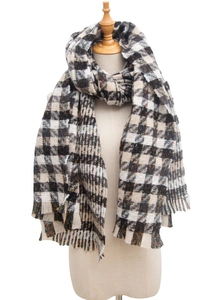 Close-up of a classic houndstooth scarf with soft fringe edges and woven texture