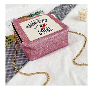 Detail of pink sequin crossbody bag with fuel gauge embroidery and gold chain strap