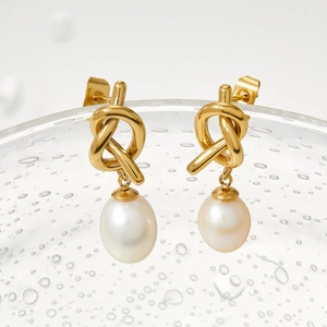 Elegant gold knot stainless steel earrings featuring lustrous natural freshwater pearls