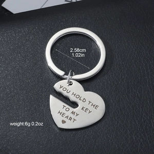 Stainless steel heart keychain engraved with You Hold The Key To My Heart text and dimensions