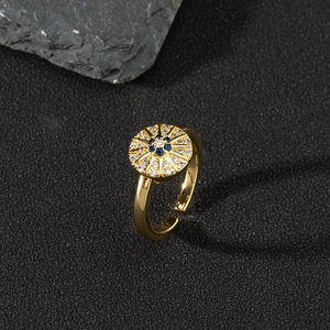 Macro shot of evil eye adjustable ring featuring blue and white zircon pavé setting
