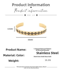 Detail view of gold C-shaped stainless steel cuff with black diamond pattern and dimensions
