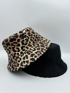 Detail of leopard print and solid black reversible bucket hat with reinforced stitching