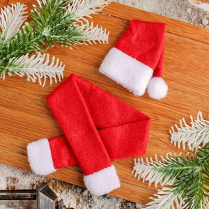 Christmas mini red hat and scarf wine bottle decoration on wooden board with snow