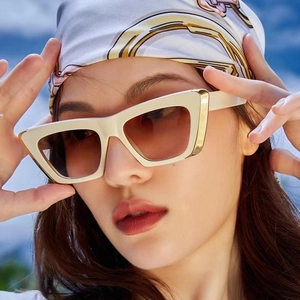 Fashionable cream cat-eye sunglasses with gold metal trim and gradient lenses for women