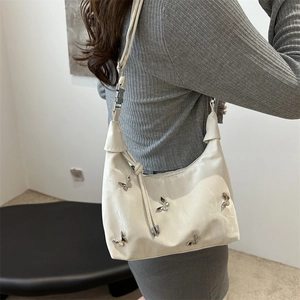 Chic white hobo shoulder bag for women with silver butterfly accents and adjustable strap