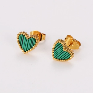 Detailed view of green striped heart earrings in gold metal setting on white background