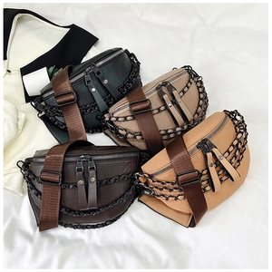 Detail view of four crocodile-patterned crossbody bags in black brown beige colors