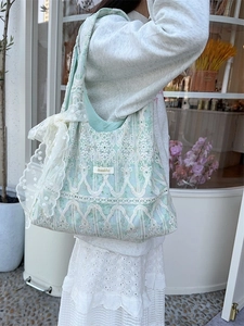 Pastel green canvas tote bag with white lace overlay and side bow decoration