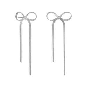 Detail of silver bow earrings with long flat snake chain tassels on a white background