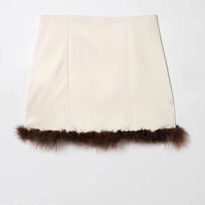 Fashionable cream mini dress with brown feather trim hem in satin finish texture