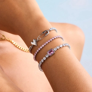 Three-piece stainless steel bracelet set with pink zircon stones and heart charm on model