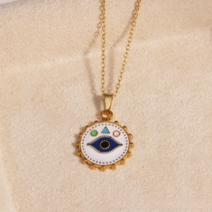 Detail of gold evil eye pendant with colorful enamel on a delicate link chain