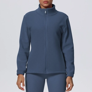 Detail of dark blue fleece jacket showing the high collar and metal zipper texture