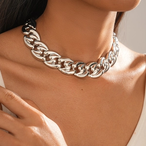 Close-up of thick silver metal link chain necklace worn on neck with polished finish