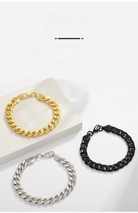 Detailed view of polished Cuban link chains in gold, silver, and black with lobster clasps