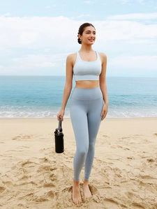 Outdoor shot of a light blue yoga set featuring a sports bra and high-waisted leggings