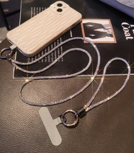 Macro view of luxury full rhinestone phone lanyard with steel buckle and silver patch