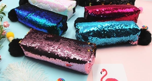Detail of reversible sequin pouch with fluffy pompom zipper and DIY color-changing effect