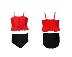 Detail of girls' two-piece swimsuit featuring red ruffled top and black high-waist bottom