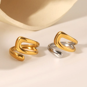Detail of minimalist stainless steel open rings in gold and mixed silver finish