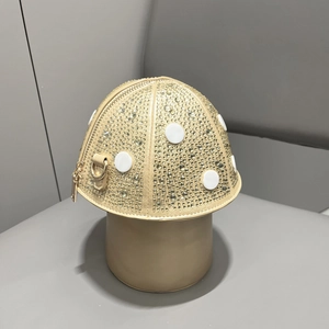 Detailed close-up of mushroom-shaped handbag featuring sparkling rhinestones and white polka dots