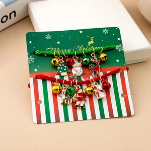 Detail of Christmas bracelet set with enamel pendants on Merry Christmas display card