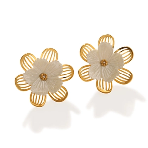 Macro detail of 18k gold flower earrings with white carved petals and small diamond accent