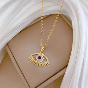 Luxurious gold Evil Eye pendant necklace with blue crystals and sparkling diamond accents