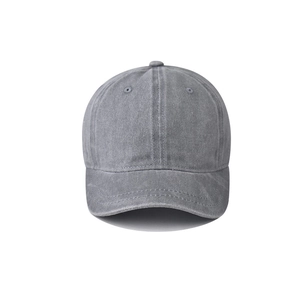 Close-up of the washed grey cotton fabric and stitching details on a short brim baseball cap