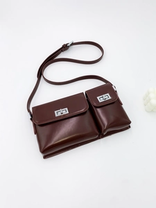 Deep brown double-pocket baguette bag with silver twist locks and a minimalist PU finish