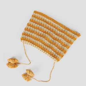 Close-up of yellow striped knit hat texture showing detailed crochet work and tassels