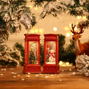 Detail of red Christmas telephone booth lantern with snowman and warm LED lighting
