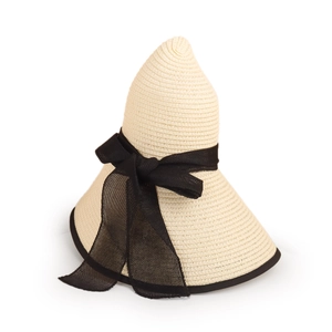 Detailed view of beige straw sun hat featuring a large black mesh bow and woven texture