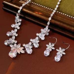 Luxury zircon flower necklace and teardrop earrings set on vintage leather background