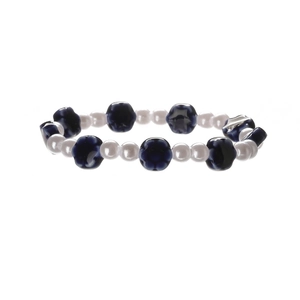 Close-up of blue ceramic flower beads and white round pearls on a beaded bracelet