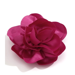 Detailed top view of a fuchsia fabric flower brooch with multi-layered silk-like petals