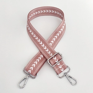 Pink nylon bag strap with white arrow pattern and silver metal hardware details