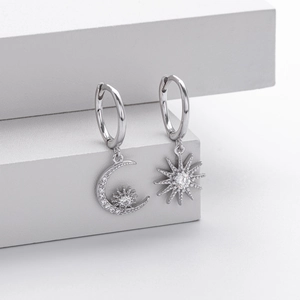 Close-up of S925 silver asymmetric hoop earrings with star and moon zircon charms