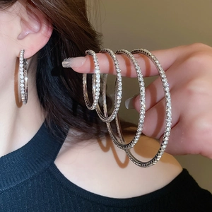 Detail of four graduated sizes of silver plated hoop earrings with full pave crystal setting