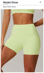 Detail view of high-waisted yoga shorts in light yellow green with side pockets