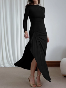 Detail of elegant black slim fit dress with waist ruching and asymmetrical side slit