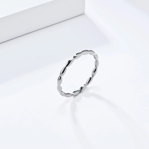 Detailed view of a silver titanium steel ring with bubble design on a white background