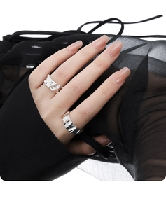 Macro view of adjustable S925 silver rings featuring unique irregular pleated metal textures