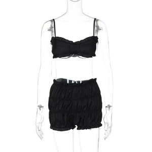 Detail of black two-piece set featuring pleated camisole top and high waist shorts