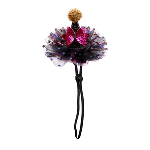 Detail of pet party hat with black mesh, gold glitter pompom, and adjustable chin strap